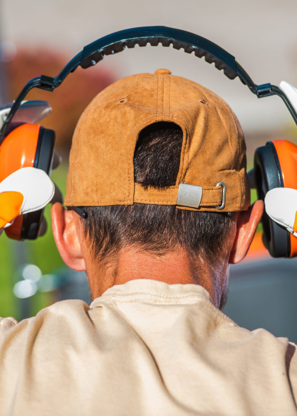 Worker Wearing Noise Reduction Ear Muffs. Loud Noises Job.